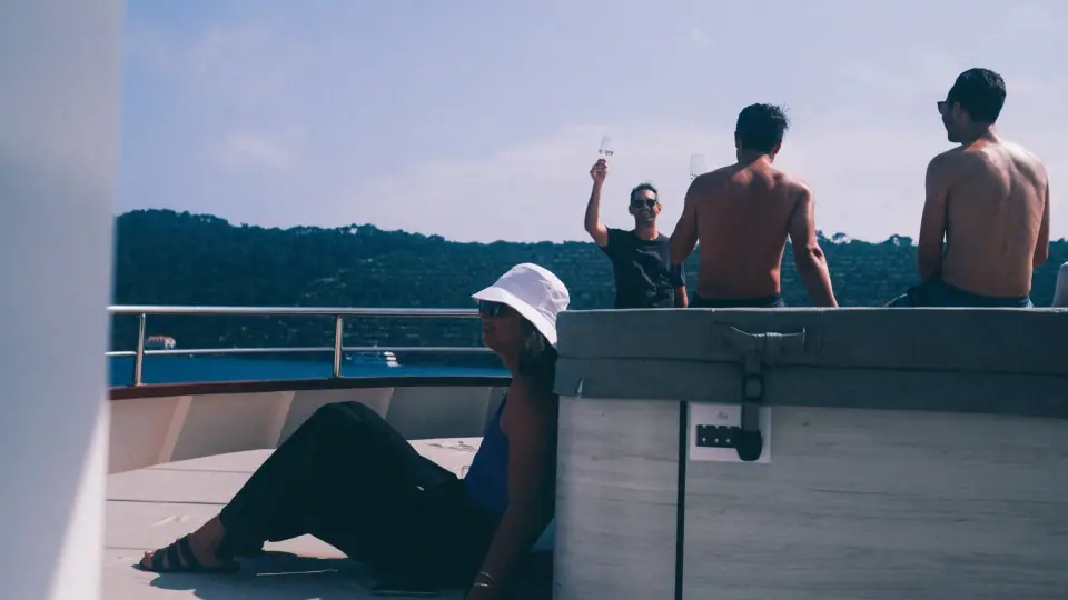 Separated silhouettes and gestures on a boat deck.