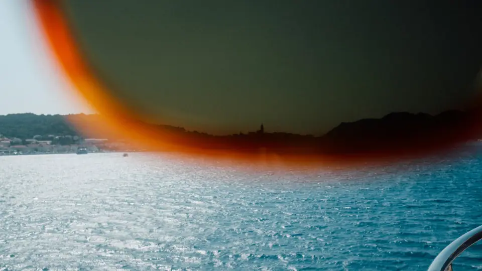 A seascape seen through a warm-toned translucent obstruction.
