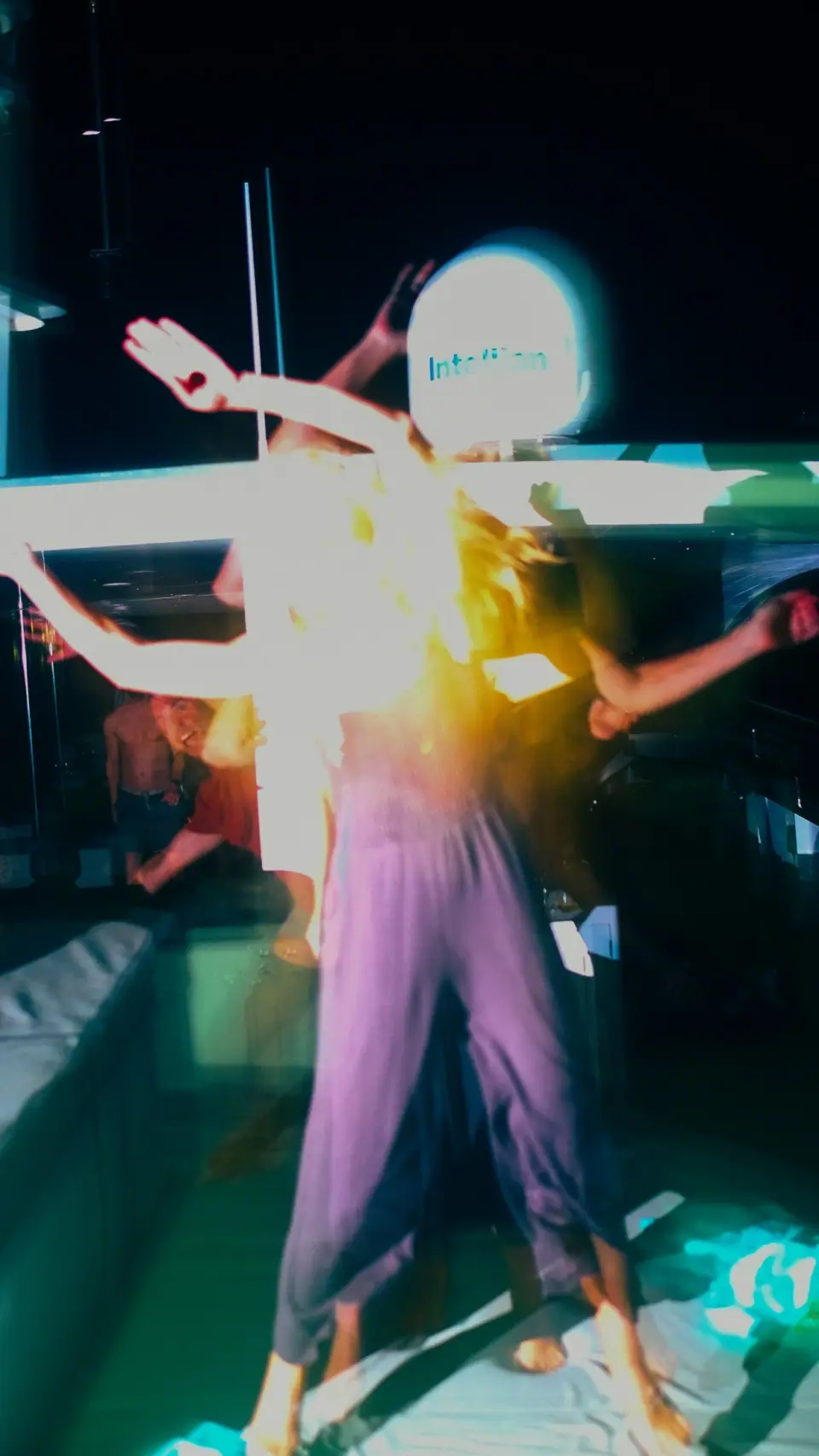 A dancer shown with bright color and overlapping movement.
