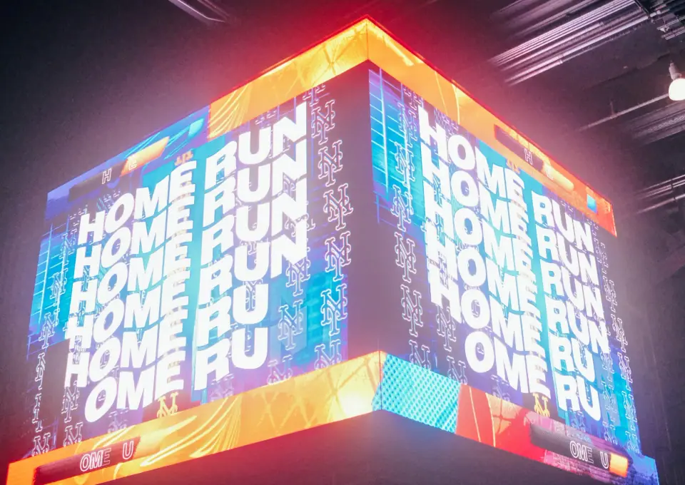 Bright lettering and converging planes fill a scoreboard.