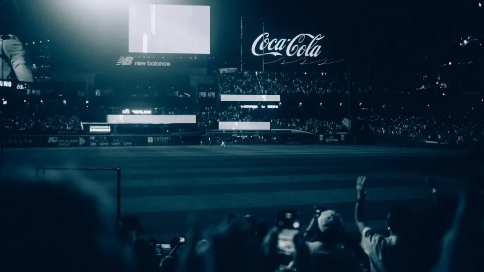 A stadium in deep blue tones with illuminated signage.