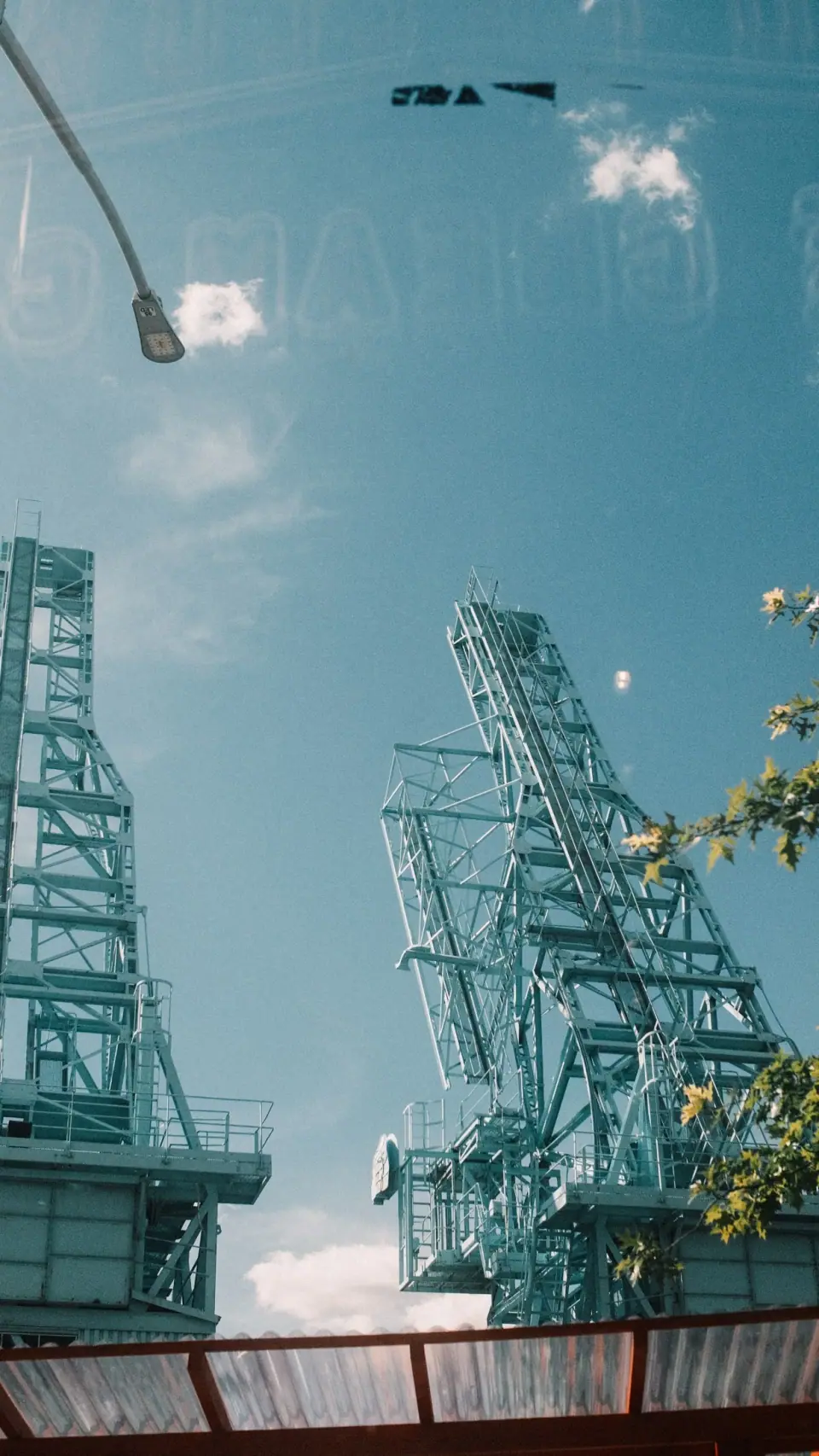 Construction geometry appears within a pale blue reflection.