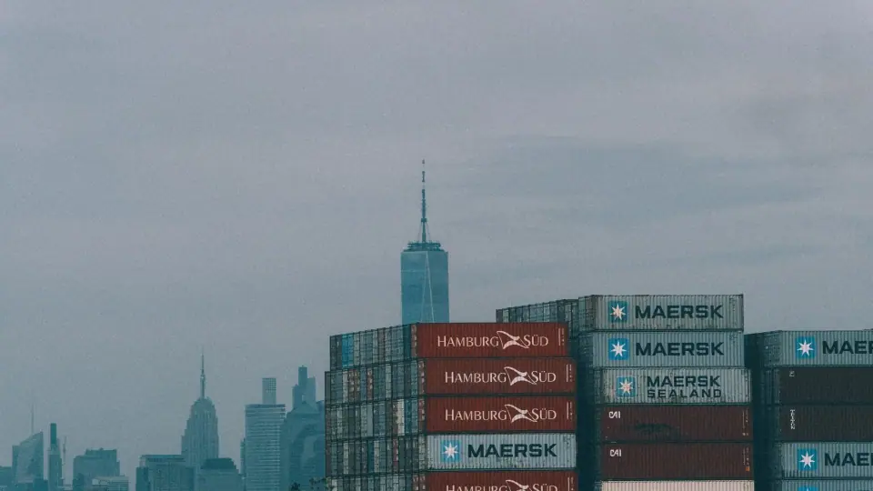 Stacked containers form industrial layers across the skyline.