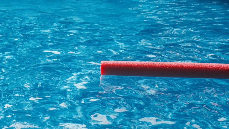 A single red line crosses bright, rippling blue water.