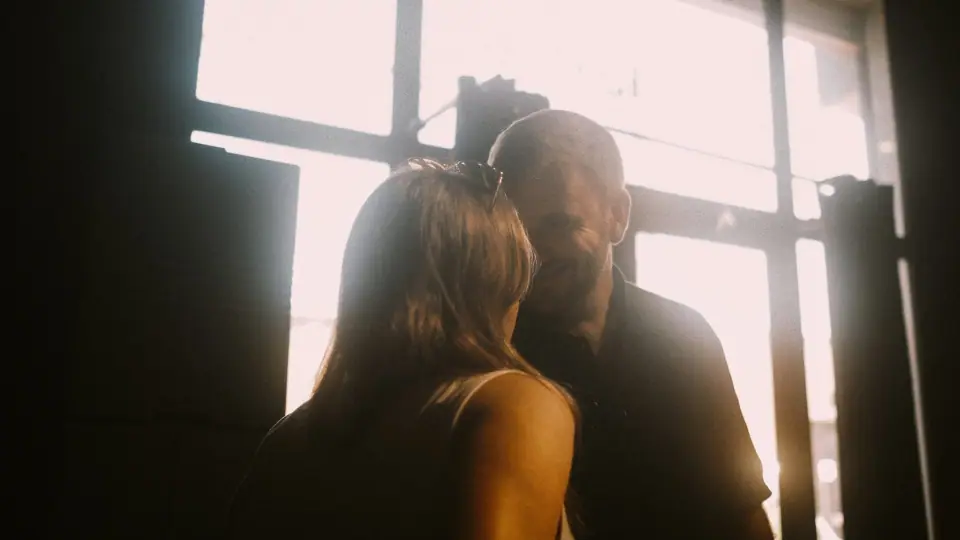 Backlit figures are surrounded by soft flare.