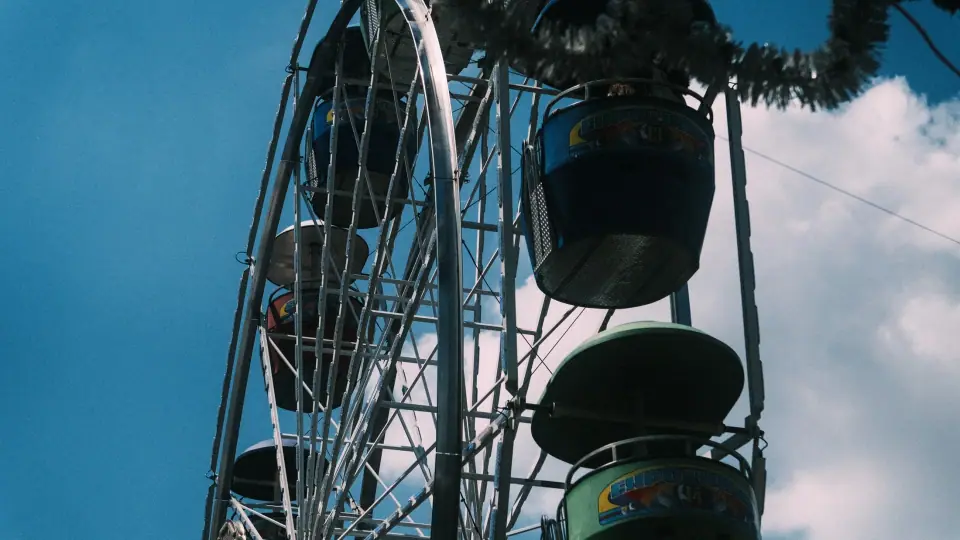 A dark wheel structure and suspended shapes are seen from below.
