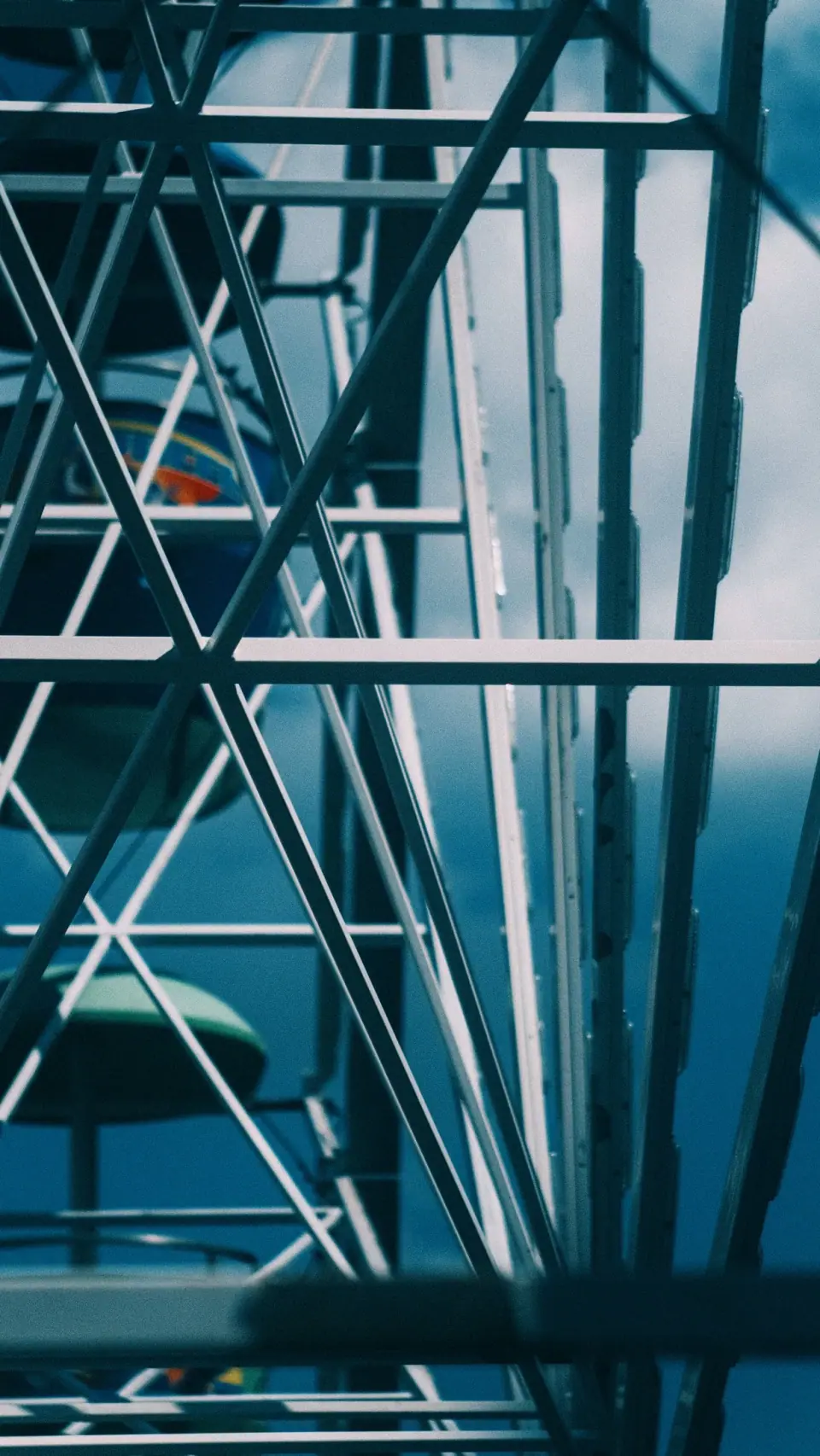 Teal metal and shadows form intersecting diagonals.