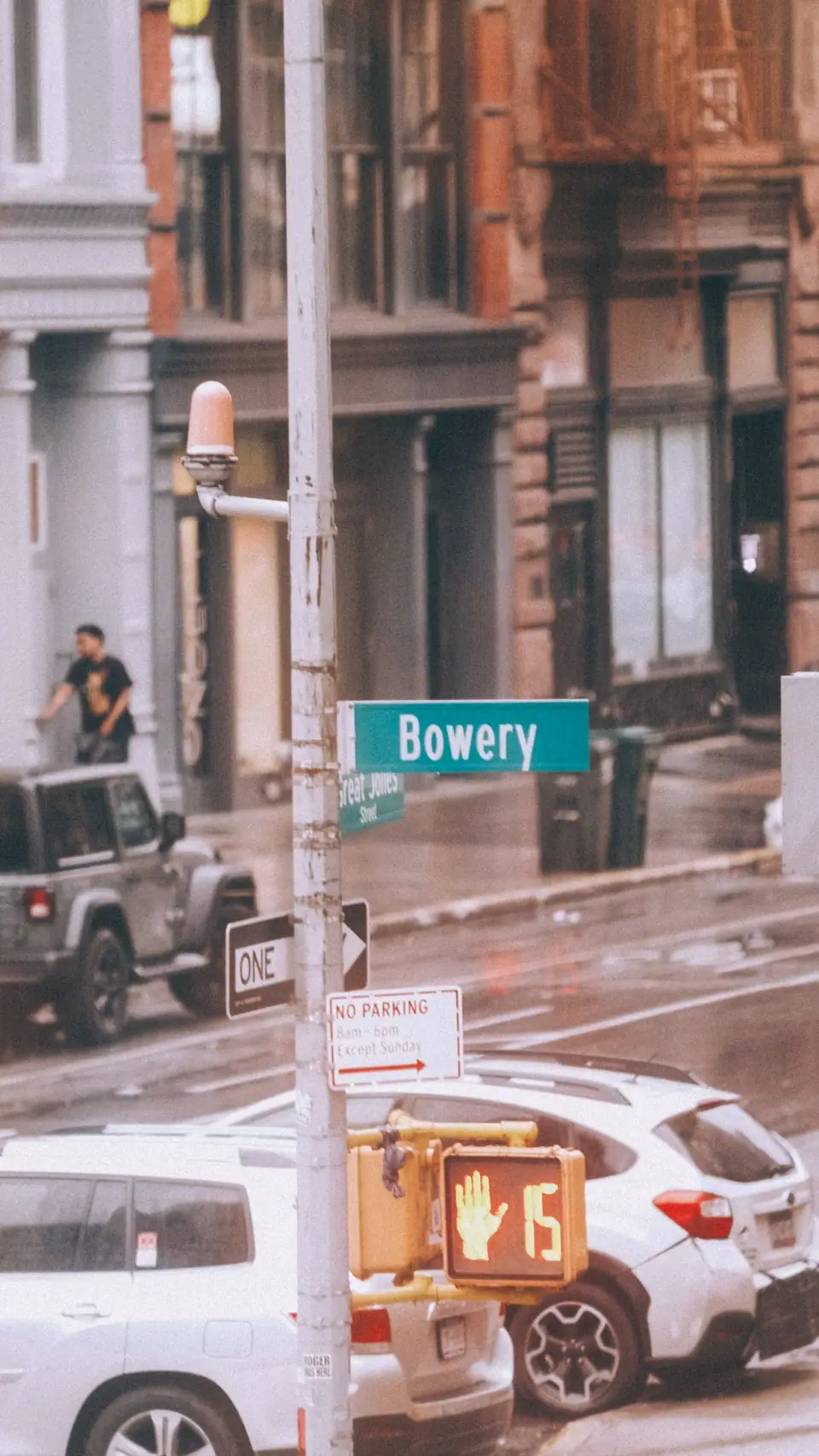 Overlapping signs and traffic fill a compressed street view.
