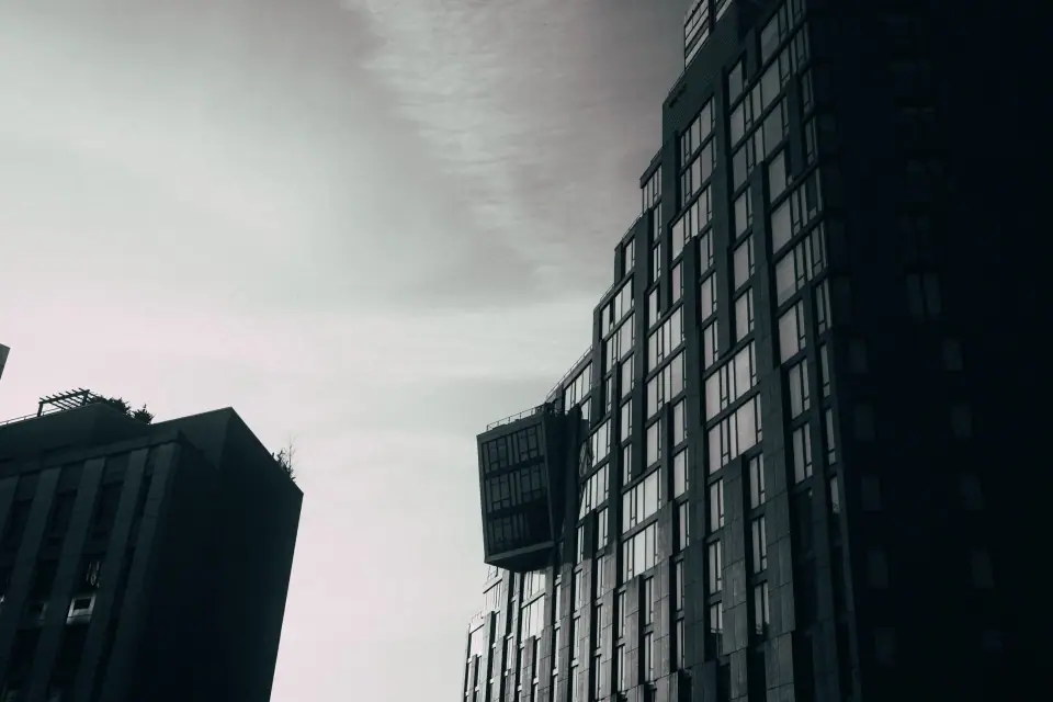 Converging building edges frame a pale sky.