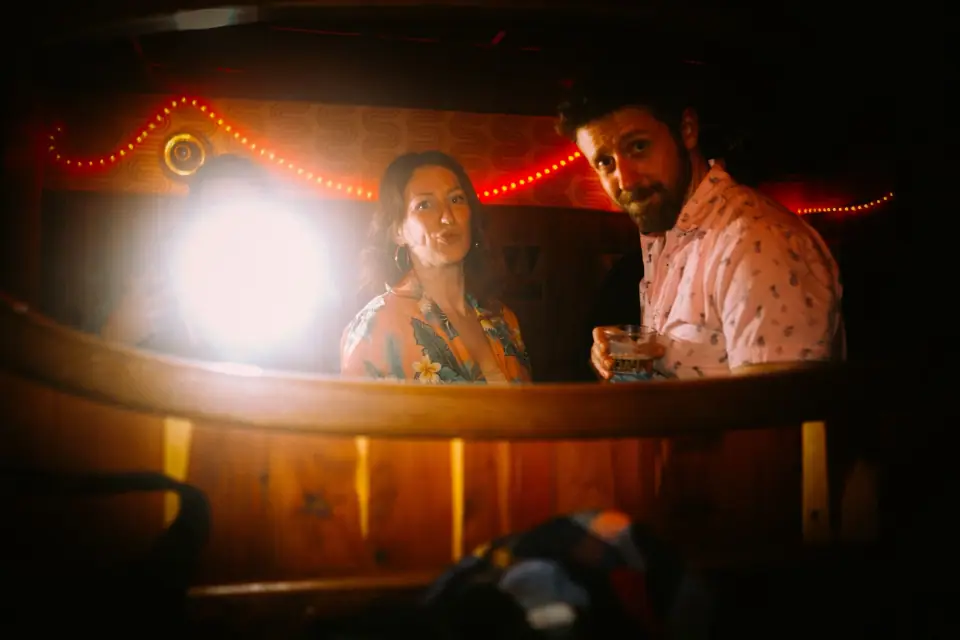 A bar scene framed by a mirror and illuminated with direct flash.