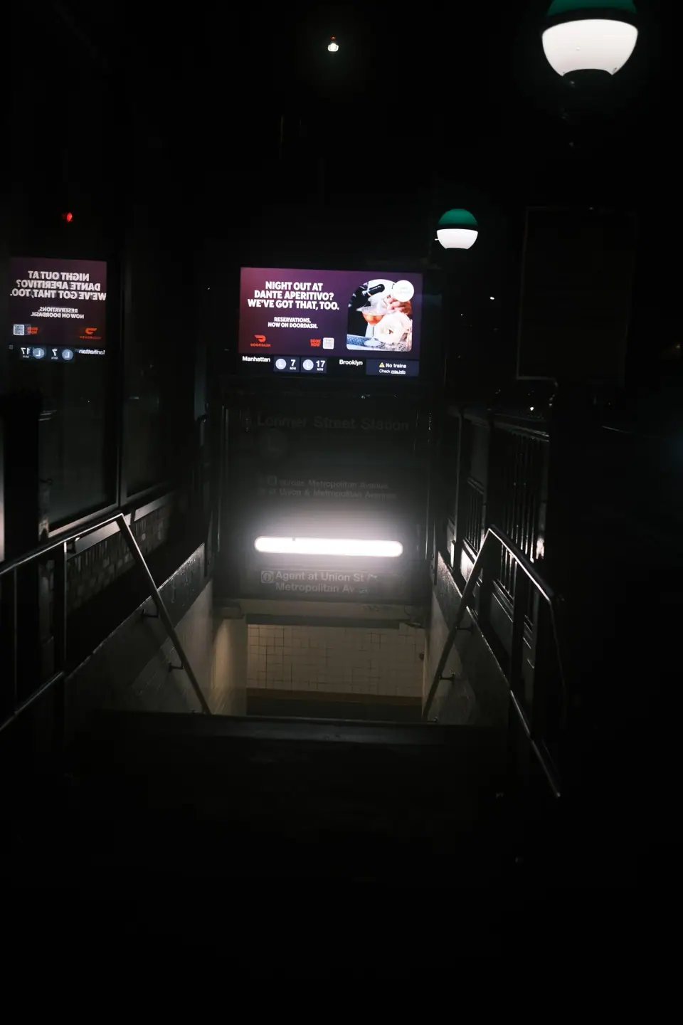 Stair rails beside a bright horizontal light.